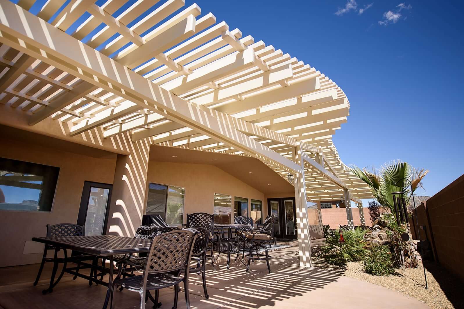 Patio with lattice pergola and seating.